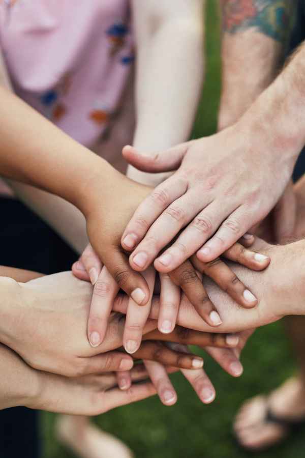 diverse group with hands on top of each other