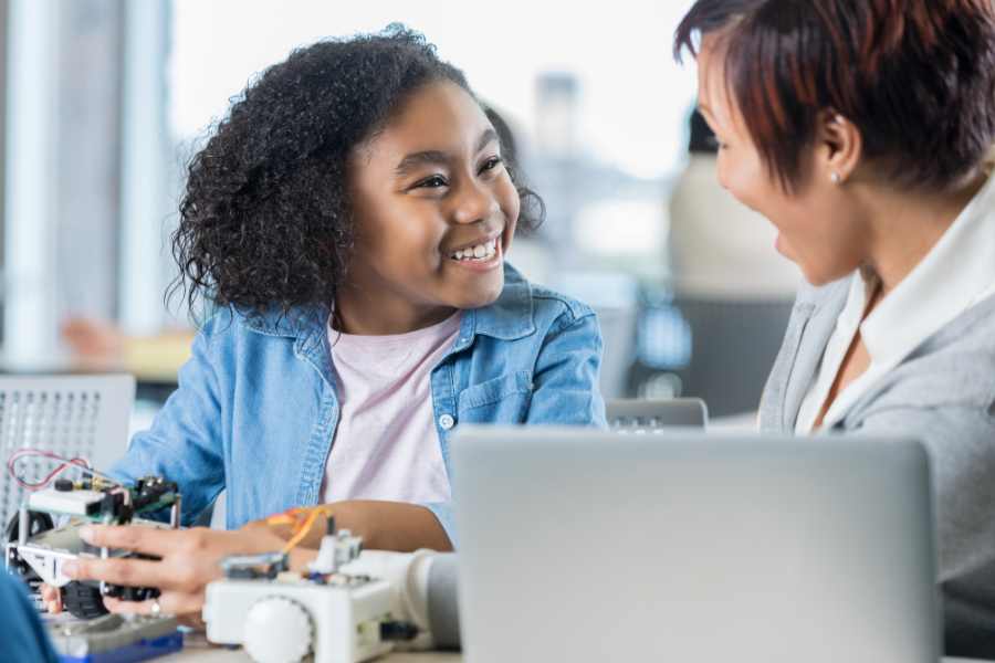 Student smiles at helpful teacher.