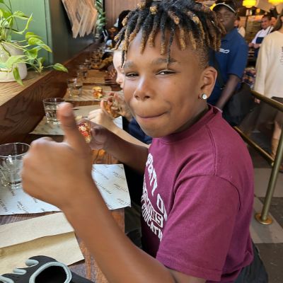 Young boy shows his approval with thumbs up