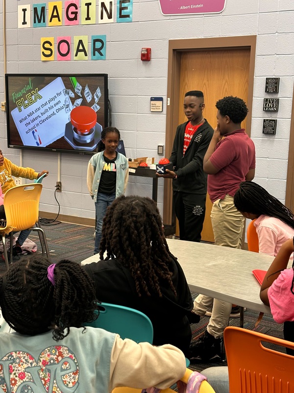 Caden explains financial literacy to students