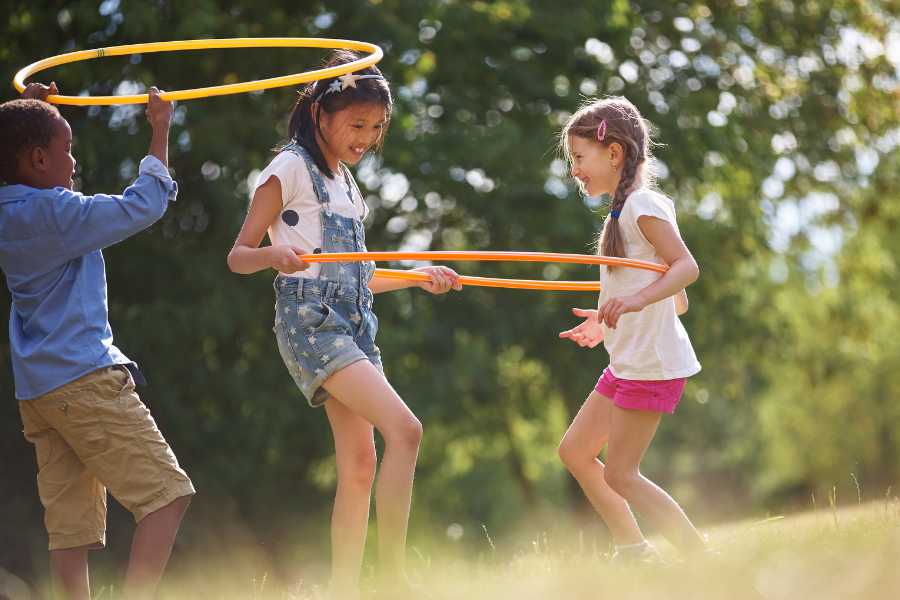 Kids playing inside a hula hoop