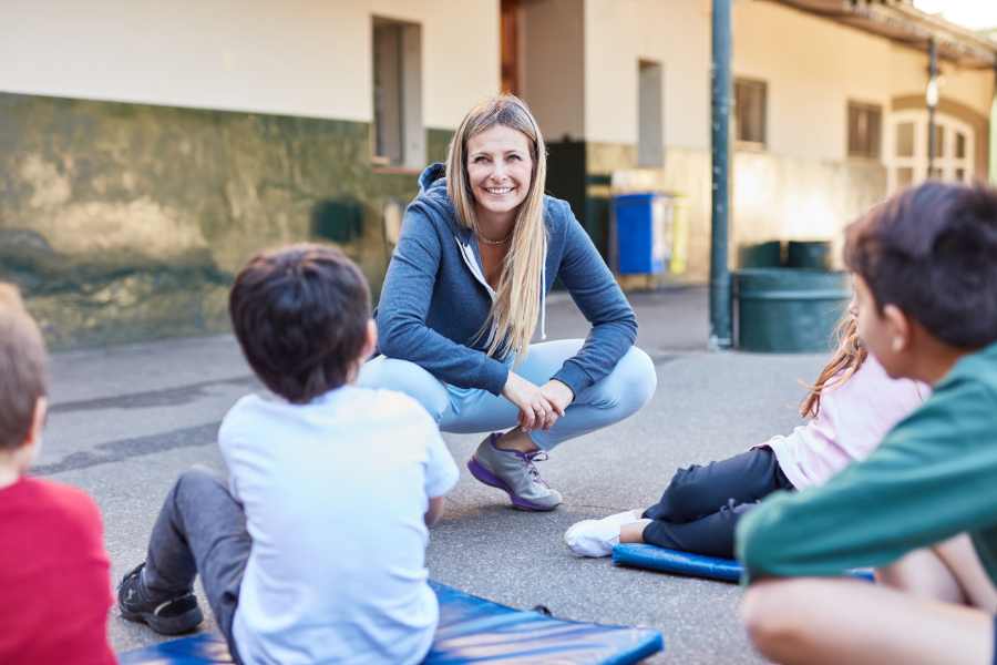 Empathy-First Approach900x600 Teacher gathered with students