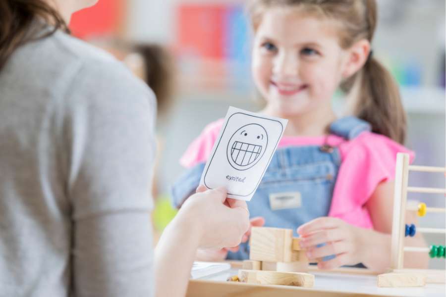Teacher holds an Emotion Card