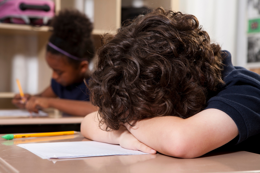 Behavior Blog Child lays head on desk