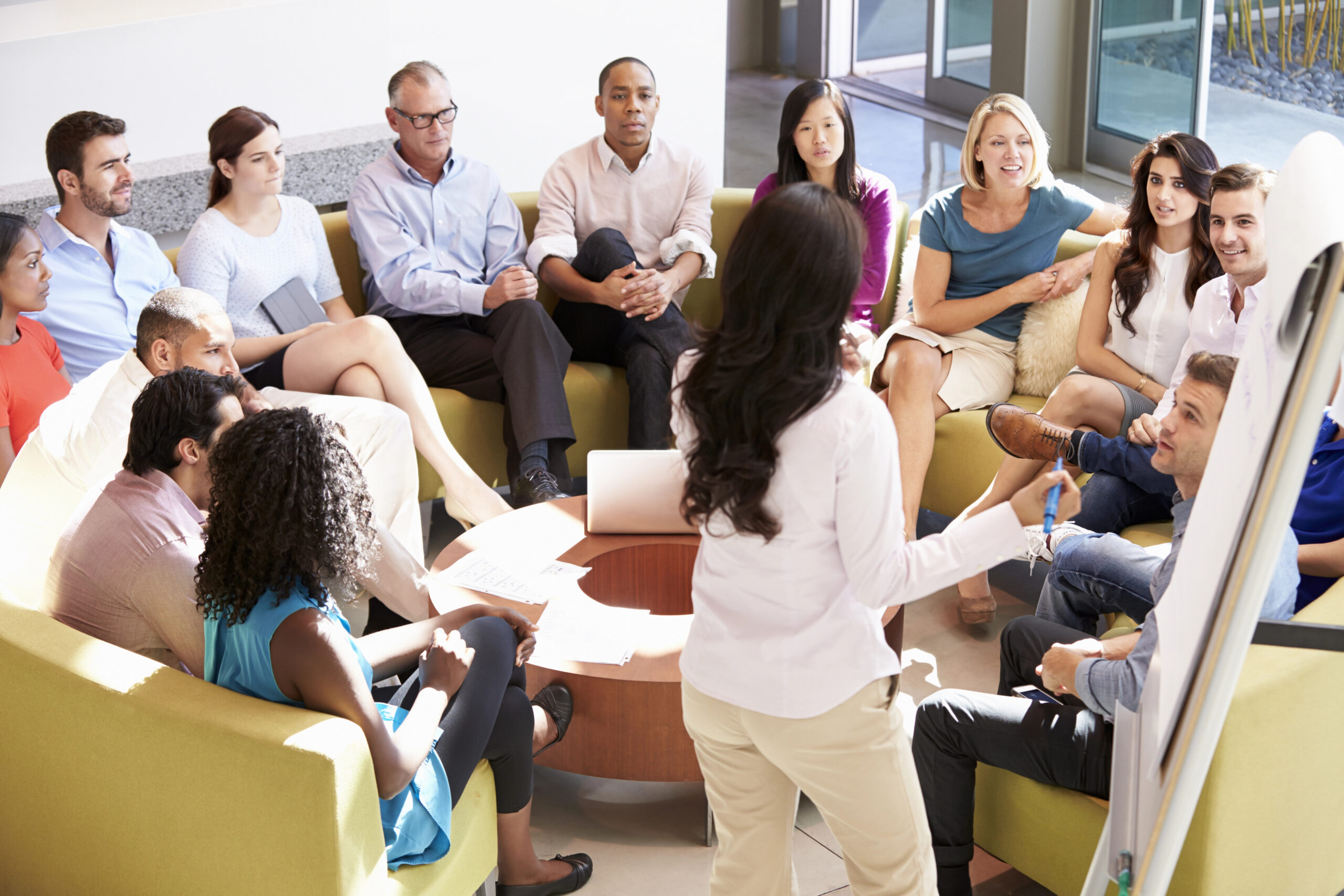 Team members sitting in a circle for a meeting